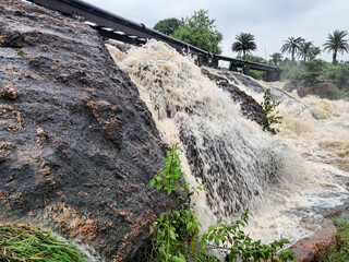 Turbulent River Water Rushing Beneath Bridge in Purulia, India. Beautiful waterfall in the rainy...