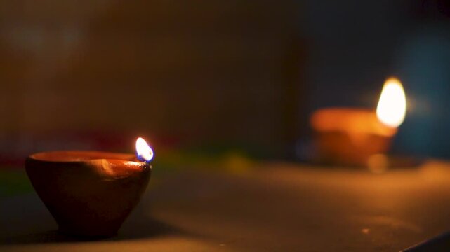 Illuminating Diyas during Diwali night in Indian home. Traditional clay Diya.  Warm and festive atmosphere during Indian festival. Happy Diwali background.