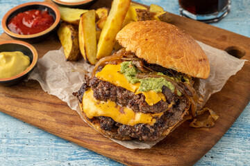Smash burger with cheddar cheese and caramelized onions, served with fries