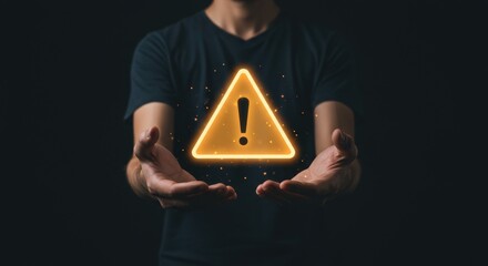 Man Holding Glowing Warning Sign With Exclamation Mark Symbol Above Open Hands in Dark Background