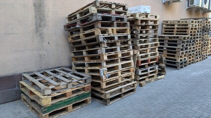Stacked Wooden Pallets Arranged Neatly within an Urban Setting for Various Purposes