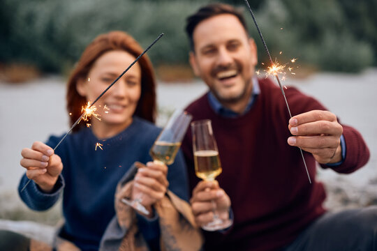 Close up of couple using sparklers while celebrating their anniversary.