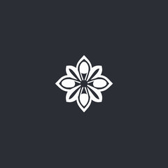 White floral design with symmetrical petals and a central circle on a dark gray background.