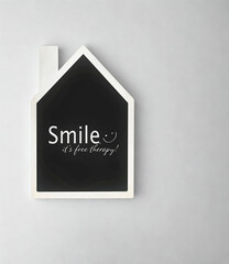 Chalkboard house sign with smile message