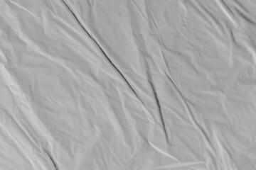 Plastic texture with wrinkles and folds, isolated transparent background. Crumpled synthetic surface for design, packaging and overlay