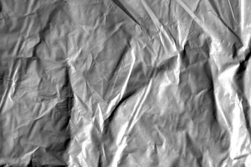 Plastic texture with wrinkles and folds, isolated transparent background. Crumpled synthetic surface for design, packaging and overlay