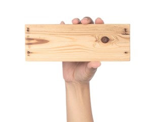 Human hand holding a rectangular wooden plank against a black background