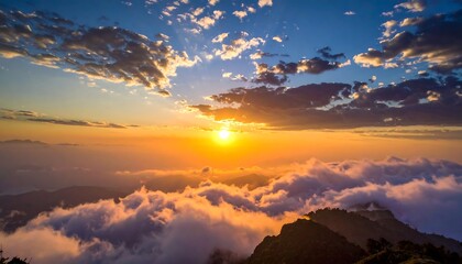 Fototapeta premium Golden sunset over cloud-covered mountains with vibrant sky
