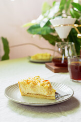 sliced homemade apple crumble cheese tart on ceramic plate
