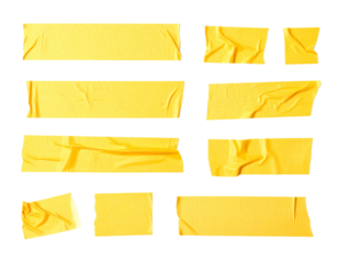 Assortment of yellow adhesive tape pieces, various sizes, placed against a black backdrop