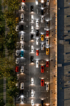 Aerial night view of city street traffic with cars and illuminated roads
