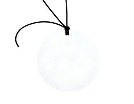 A blank, circular object with a thin, black cord attached at the top, against a dark backdrop