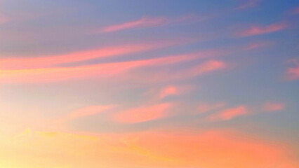 In sunset time, the yellow and pinku cirrus clouds in blue sky