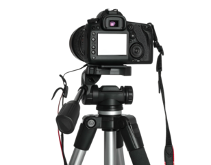 Rear view of digital single-lens reflex camera on a tripod against a plain backdrop