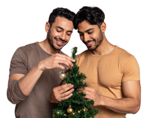 Happy gay mixed ethnicity couple decorating a small Christmas tree 