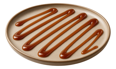 Thick caramel sauce elegantly drizzled in parallel lines on a round beige plate.