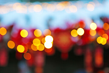 Red Chinese lanterns in the snow are out of focus. Chinese New Year. Background for New Year's card. Out of focus.
