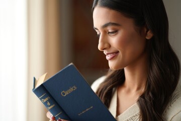 Woman Engaged in Reading a Classic Literature Book with a Contented Expression in a Cozy Indoor Setting