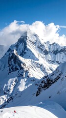 Obraz premium Majestic snowy peak under partly cloudy sky with bright sunlight