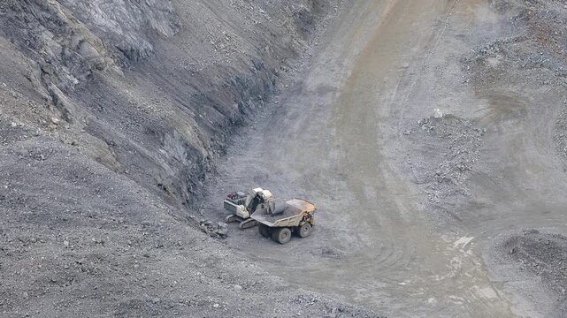 Open pit mine industry, aerial view. Big yellow mining truck for coal working in quarry.