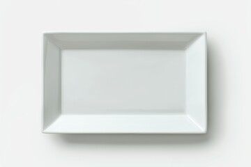 Fototapeta premium A simple, rectangular white plate on a neutral background, perfect for serving food or decorative purposes.