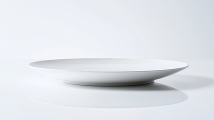 A minimalist, elegant white plate with subtle ridges, showcasing a modern design and a smooth surface, perfect for serving food.