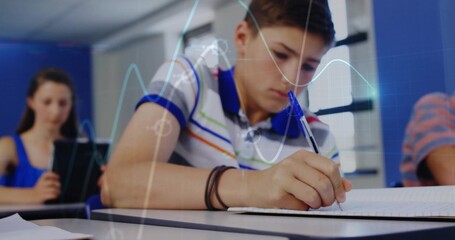 Writing student in striped polo shirt focusing on notebook at school, with pen tablet desks chairs