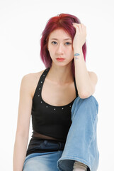 Asian confident young woman purple short hair posing  sitting on cube box smile wearing black...