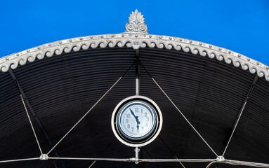 Clock on the roof of the ferry station to Paradiso on the southern shore of Lake Lugano in the canton of Ticino, Switzerland