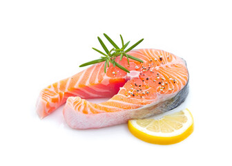 Fresh salmon steaks, spices and lemon slices on white background