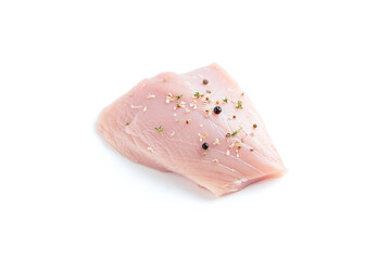Raw turkey fillet isolated on white background with spices.