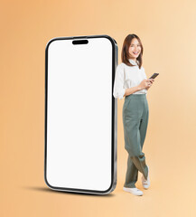 Happy Asian business woman hand touching a large smartphone screen isolated on beige color background, travel concept.