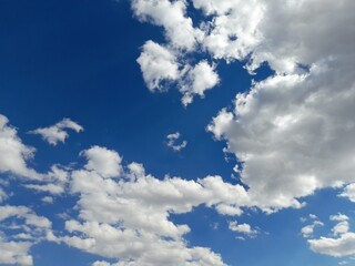 Cottony White Clouds on Blue Sky Background (Summer and Outdoor Concept)