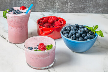 Still life with blueberries and a blueberry and sunflower seed smoothie on a treated pine wood surface