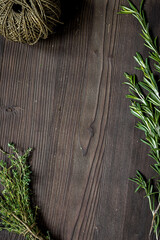 fresh herb frame on dark wooden background top view