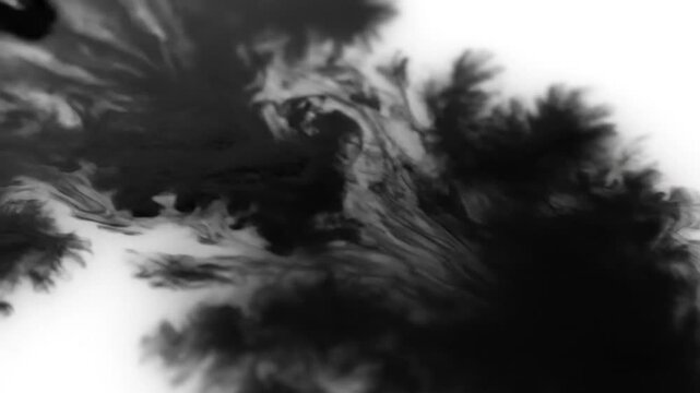 Close-up of human hand holding a pen and writing on a blank white paper surface with a blurred background