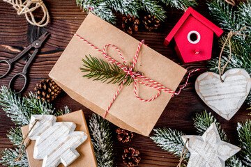 gifts boxes with fir branches on wooden background top view