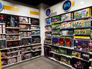 Fototapeta premium Colorful lego sets and Marvel Minecraft toy boxes on bright showroom shelves in a retail store
