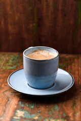 Cup of coffee on rustic wooden background. Soft focus. Copy space	