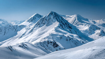 Obraz premium Snowy mountain peaks under a clear blue sky offer a stunning view of nature's winter wonderland. Majestic and serene alpine scenery.