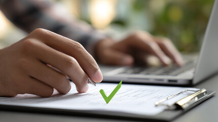 Fototapeta premium Completing the form with the right mark and a pen in hand. Using a computer to type information, and the form is now done correctly.