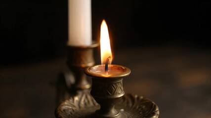 Close-up of a burning candle with a dark background, creating a warm and tranquil ambiance for meditation or spiritual practice - Powered by Adobe