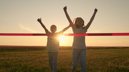 Children are winners. Little girls run to finish line. Children girls run to finish line in sun park. Victory, success. Athletic children run. Sports, child champion. Winning girl. Happy kids run lawn
