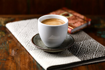 Cup of coffee on rustic wooden background. Soft focus. Copy space	