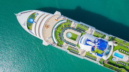 Cruise ships sailing the sea take tourists on a journey and relax on holidays.