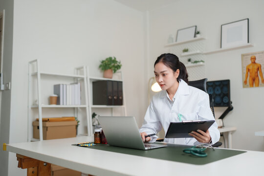 Female doctor using laptop for online consultation