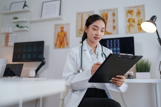 Female doctor writing medical notes in clinic