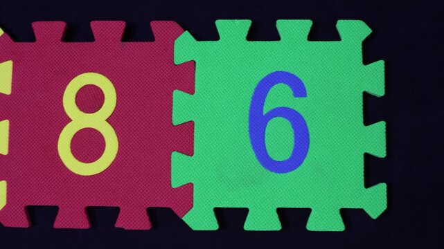 Muslim Holy Numbers 786 on foam puzzle on black background