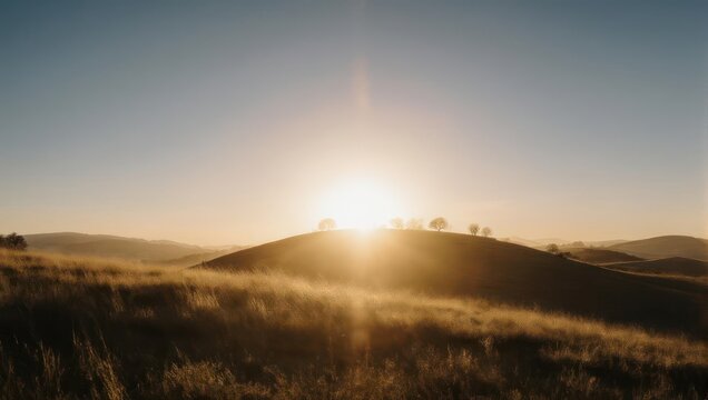 Golden Sunrise Over Rolling Hills - A Serene Landscape.