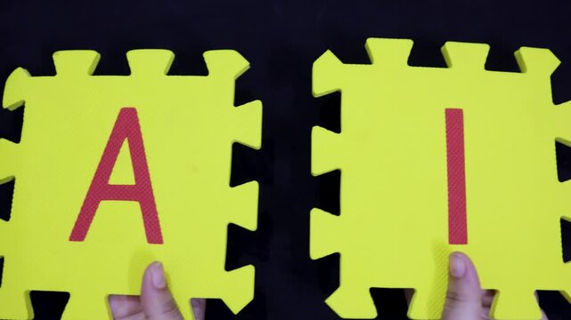 innovation and machine learning concept foam jigsaw letters a and i held up in hand